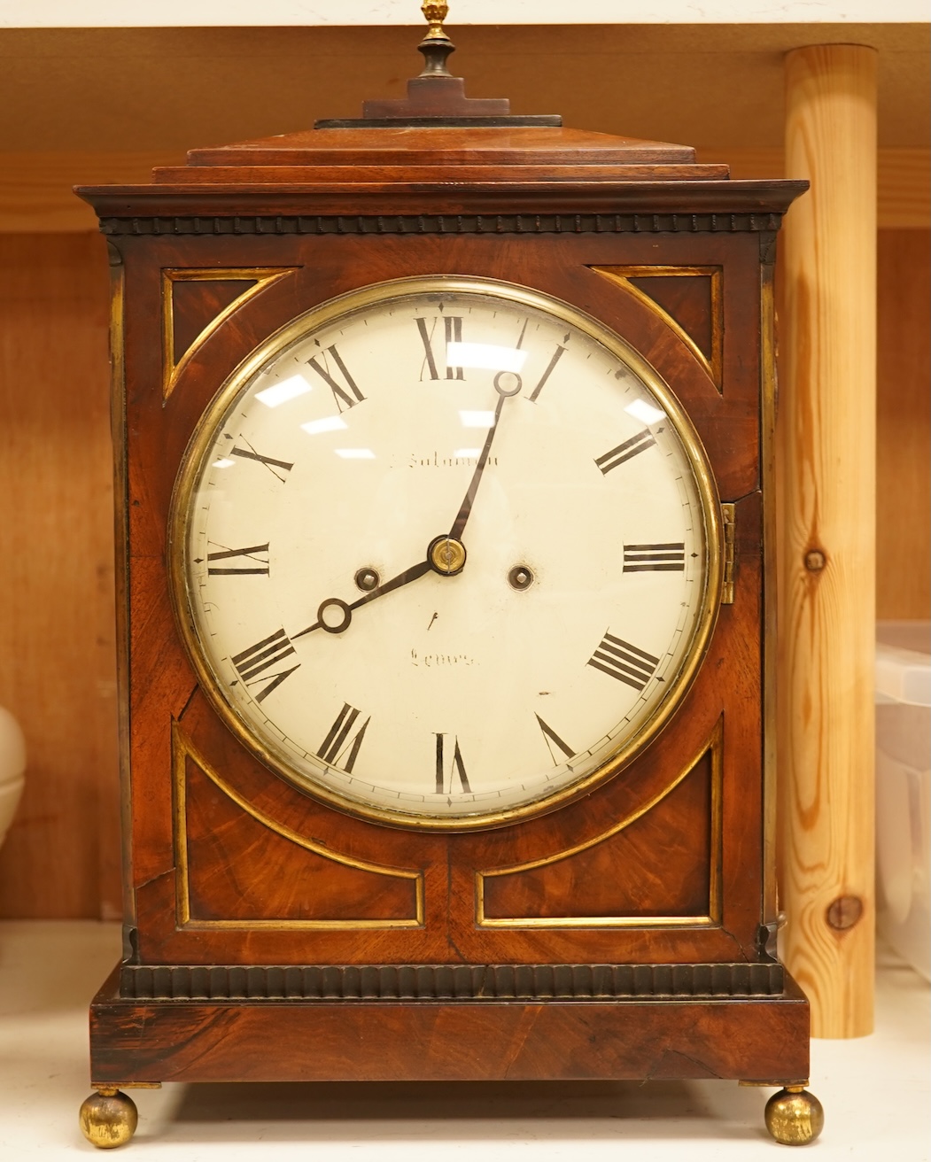 An early 19th century rosewood and brass bracket clock, striking on a bell, with pendulum and key, 47cm high